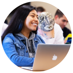 A student with a laptop engages in class discussion.